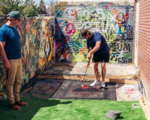 Player putting a final stroke on the Volcanic Vengeance hole.