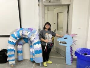 Foundations student posing with their hand-made Leviathan.