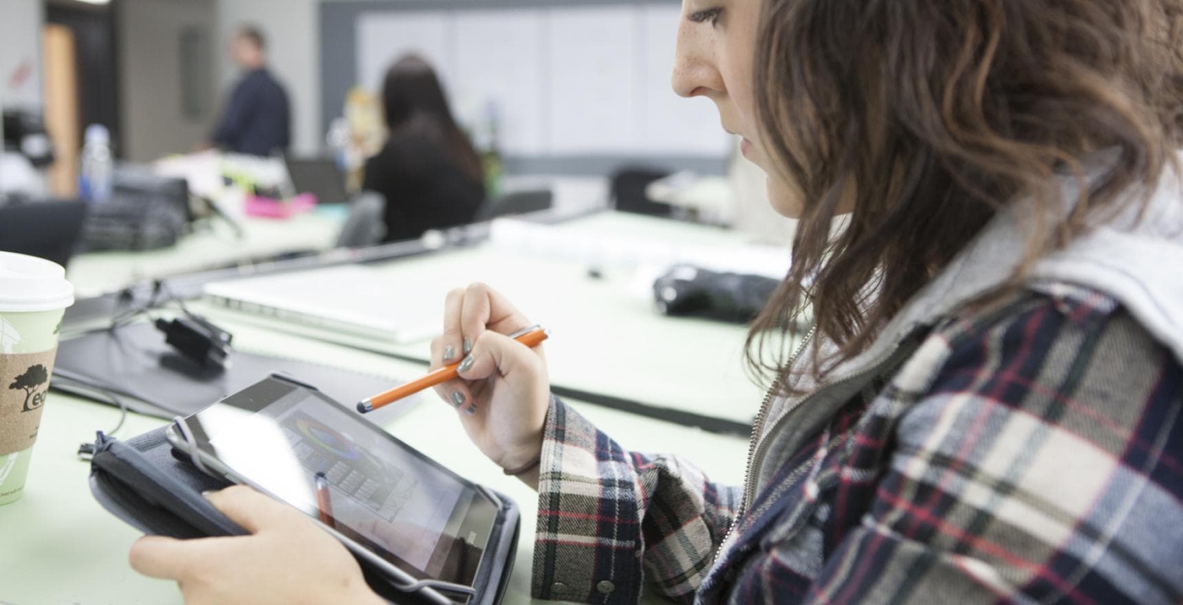 a student draws on ipad