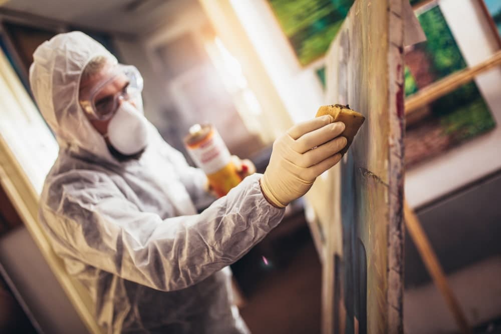 Restorer working on the painting at restoration workshop